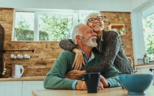 senior couple hugging and laughing at home