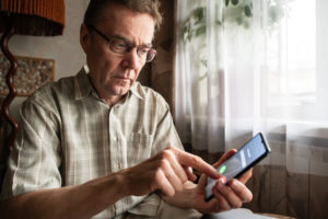 Senior man on cell phone - Fraud awareness for phone scams and digital fraud